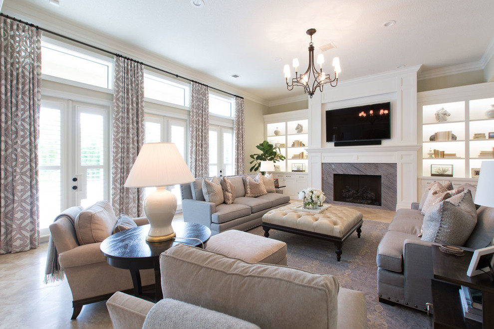 This is an example of a formal living room in Orange County with beige walls, travertine floors, a standard fireplace, a tile fireplace surround and a wall-mounted tv.