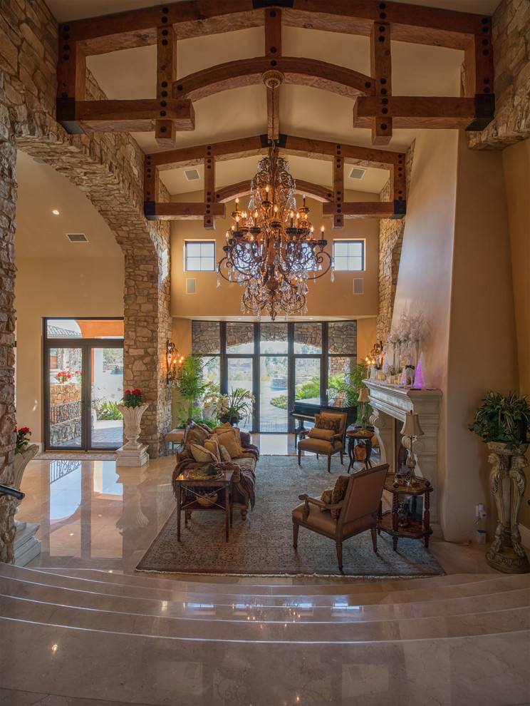 Inspiration for a mid-sized mediterranean formal open concept living room in San Diego with brown walls, marble floors, a standard fireplace, a stone fireplace surround and no tv.