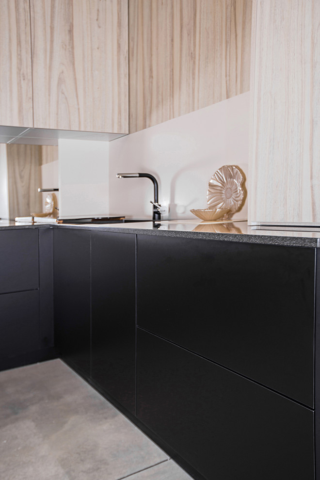 Photo of a contemporary u-shaped kitchen in Moscow with an undermount sink, flat-panel cabinets and solid surface benchtops.