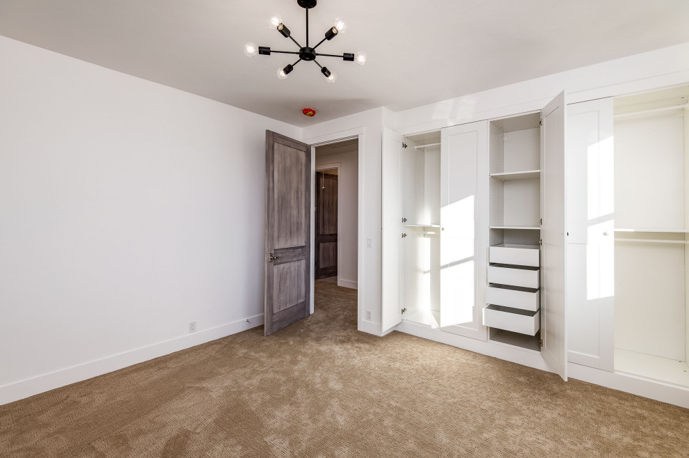 Idée de décoration pour une grande chambre d'amis blanche et bois champêtre avec un mur blanc, sol en béton ciré et un sol marron.
