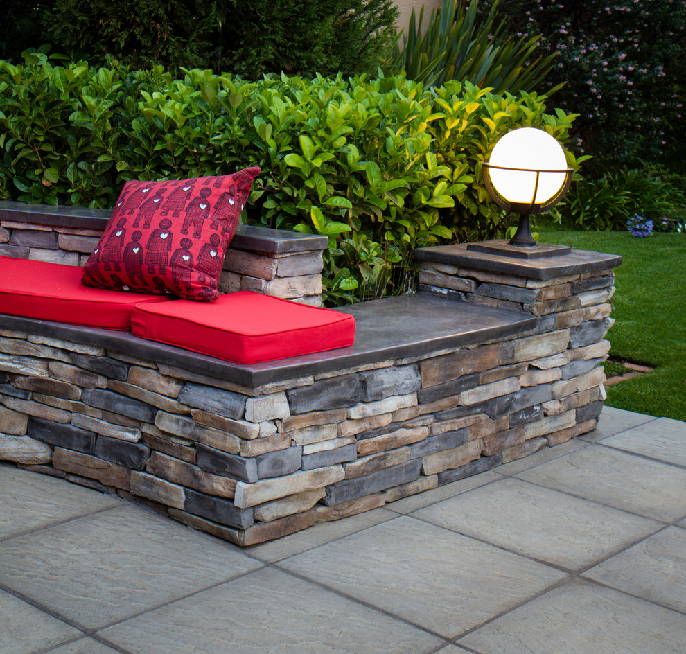Inspiration for a rustic full sun backyard concrete paver landscaping.