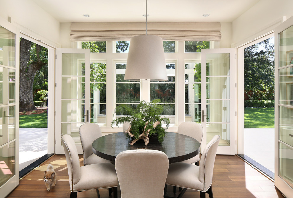 Photo of a transitional kitchen/dining combo in San Francisco with white walls and medium hardwood floors.