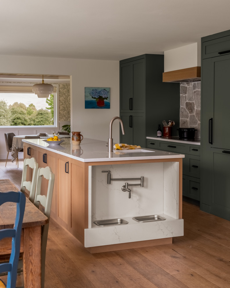 Kitchen - transitional galley medium tone wood floor and brown floor kitchen idea in Seattle with an undermount sink, shaker cabinets, green cabinets, gray backsplash, paneled appliances, an island and white countertops