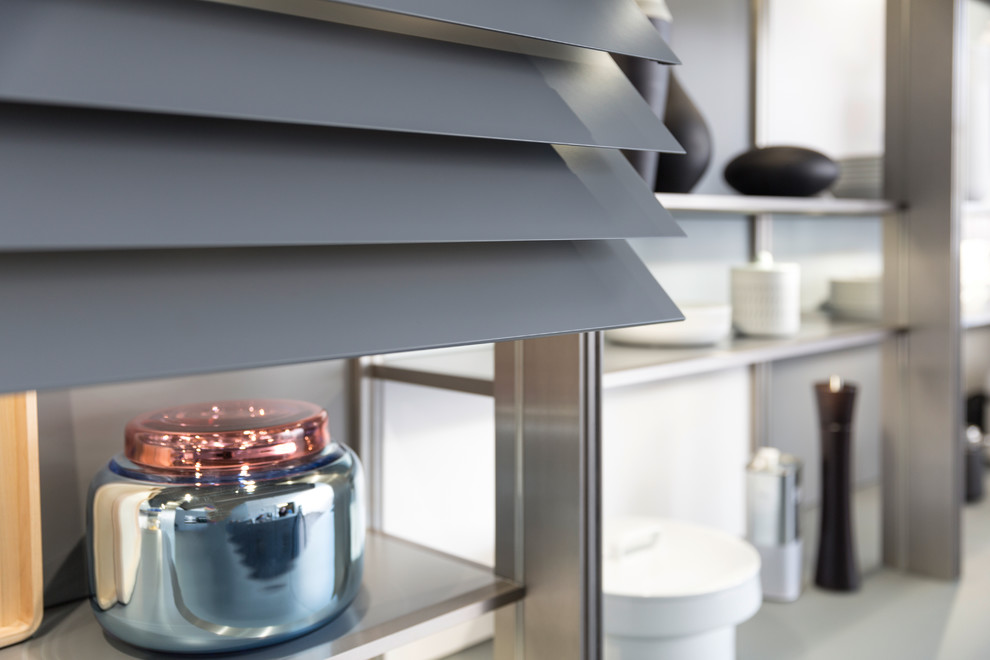 Eat-in kitchen - large u-shaped dark wood floor eat-in kitchen idea in Orange County with an undermount sink, glass-front cabinets, gray cabinets, glass countertops, gray backsplash, stainless steel appliances and an island