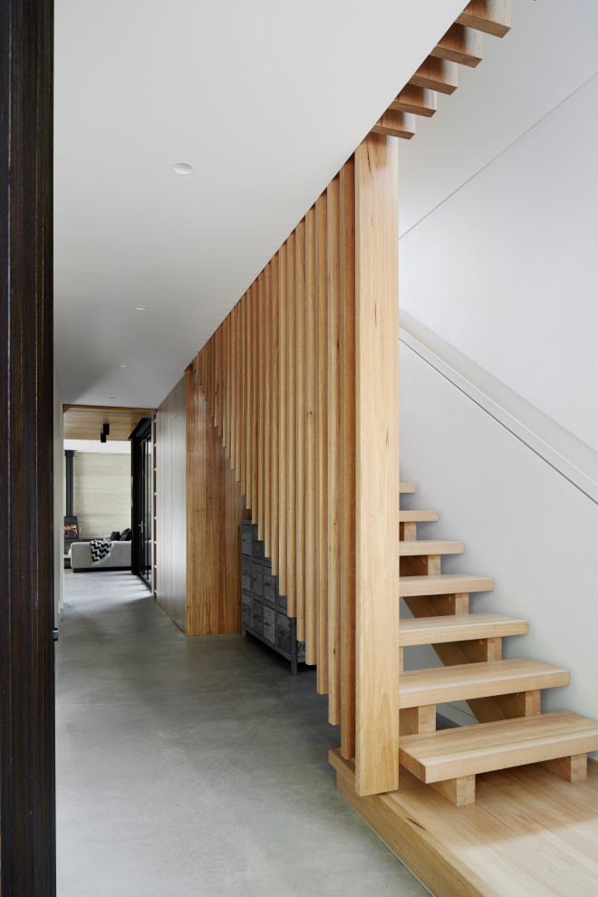 Design ideas for a mid-sized contemporary wood straight staircase in Melbourne with wood risers and metal railing.