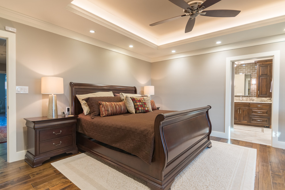 Inspiration for a mid-sized transitional master bedroom in Austin with grey walls and medium hardwood floors.