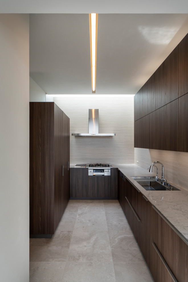 Expansive modern l-shaped separate kitchen in Kobe with an undermount sink, beaded inset cabinets, dark wood cabinets, marble benchtops, brown splashback, timber splashback, black appliances, marble floors, no island and white floor.