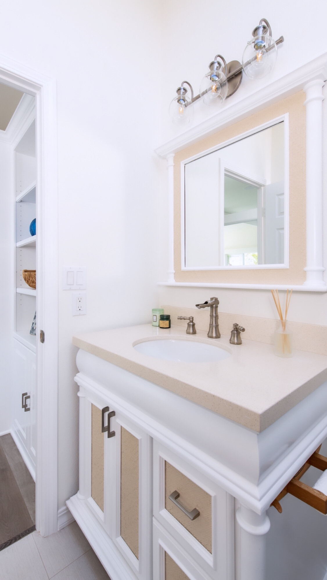 Coastal Island style vanity with rattan and white finishes.