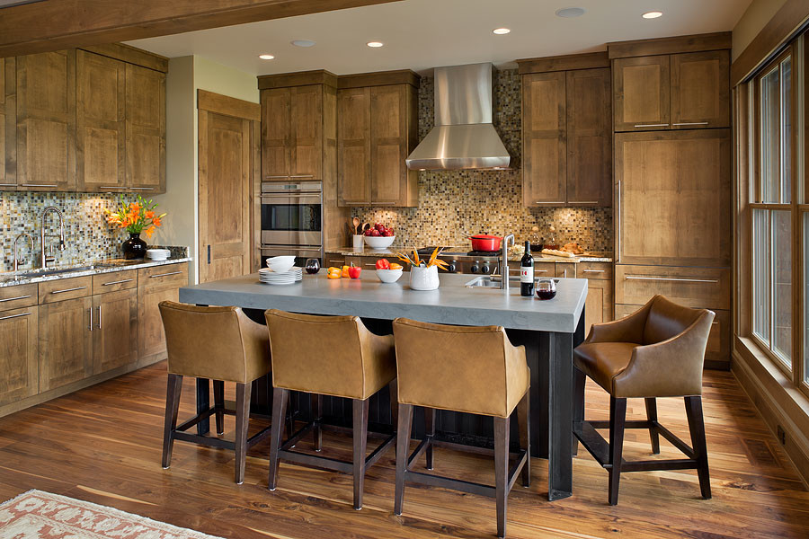 Open concept kitchen - large transitional l-shaped dark wood floor and brown floor open concept kitchen idea with an undermount sink, flat-panel cabinets, medium tone wood cabinets, granite countertops, multicolored backsplash, glass tile backsplash, paneled appliances, an island and multicolored countertops