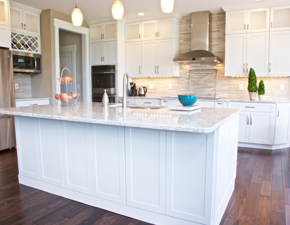 Inspiration for a mid-sized transitional galley eat-in kitchen remodel with white cabinets, granite countertops, beige backsplash, stone tile backsplash and stainless steel appliances