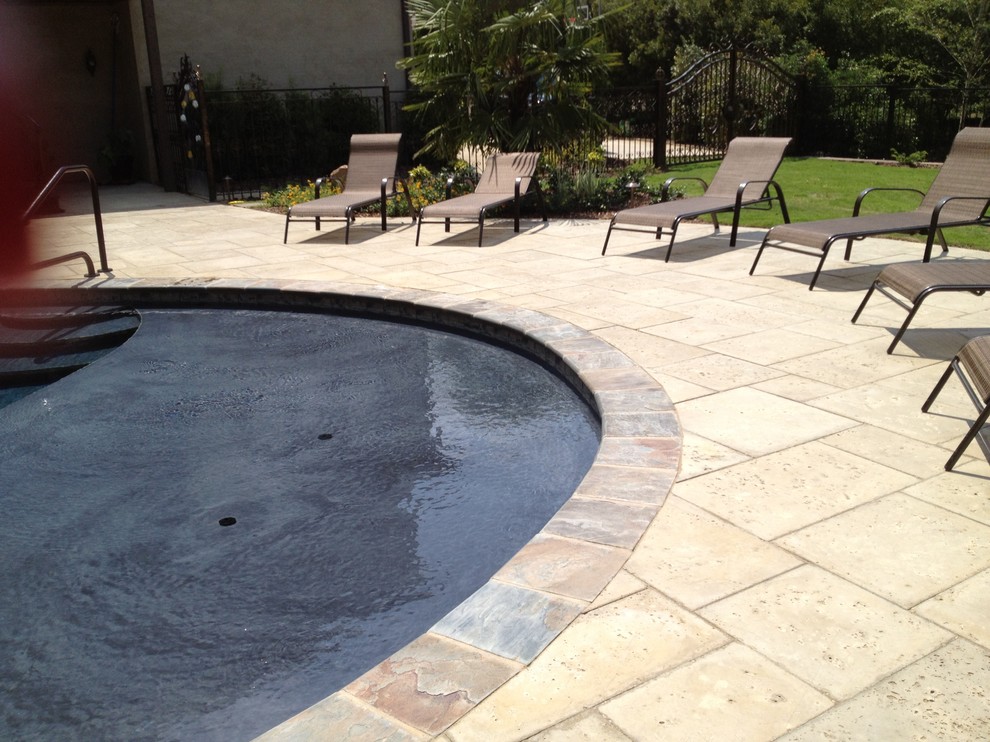 This is an example of a mid-sized traditional backyard kidney-shaped pool in Miami with concrete pavers.