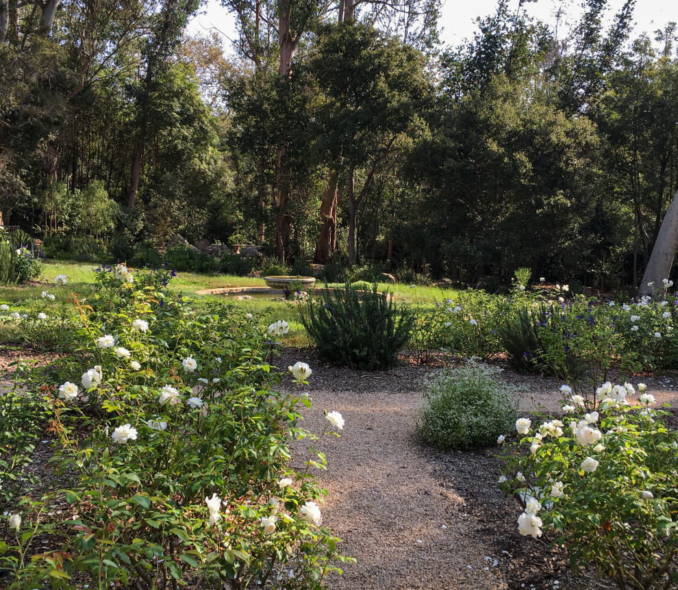 Expansive country xeriscape garden in Santa Barbara with a pond and gravel.