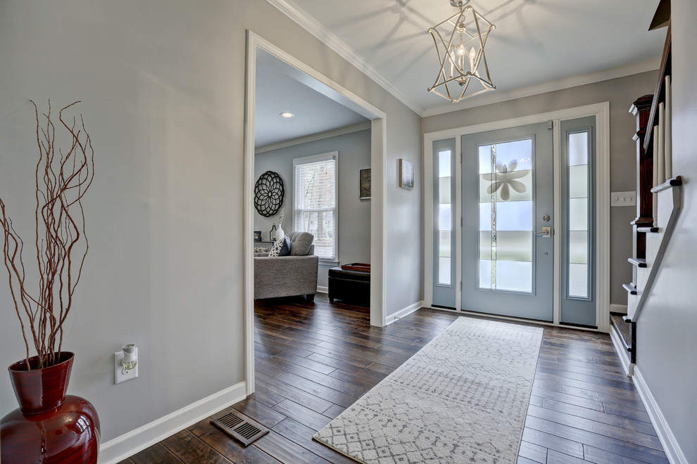 Photo of a mid-sized transitional foyer in Atlanta with grey walls, dark hardwood floors, a single front door, a gray front door and brown floor.