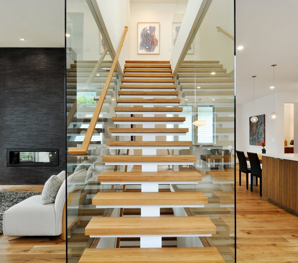 This is an example of a contemporary wood straight staircase in Other with open risers and wood railing.
