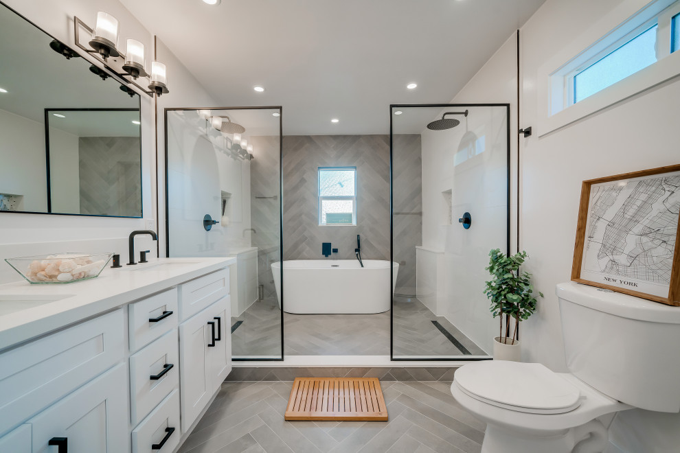 Example of a mid-sized trendy master gray tile and ceramic tile ceramic tile, gray floor and double-sink bathroom design in Los Angeles with shaker cabinets, white cabinets, a two-piece toilet, white walls, an undermount sink, quartz countertops, white countertops, a niche and a built-in vanity