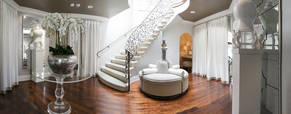 Inspiration for a mid-sized transitional medium tone wood floor and brown floor foyer remodel with white walls