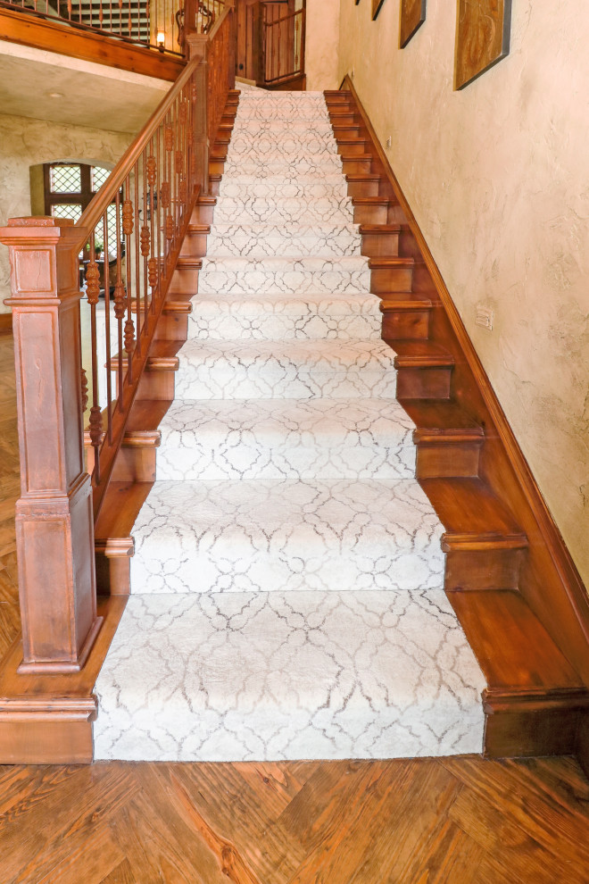 Inspiration for a large traditional carpeted straight staircase in Other with carpet risers and wood railing.