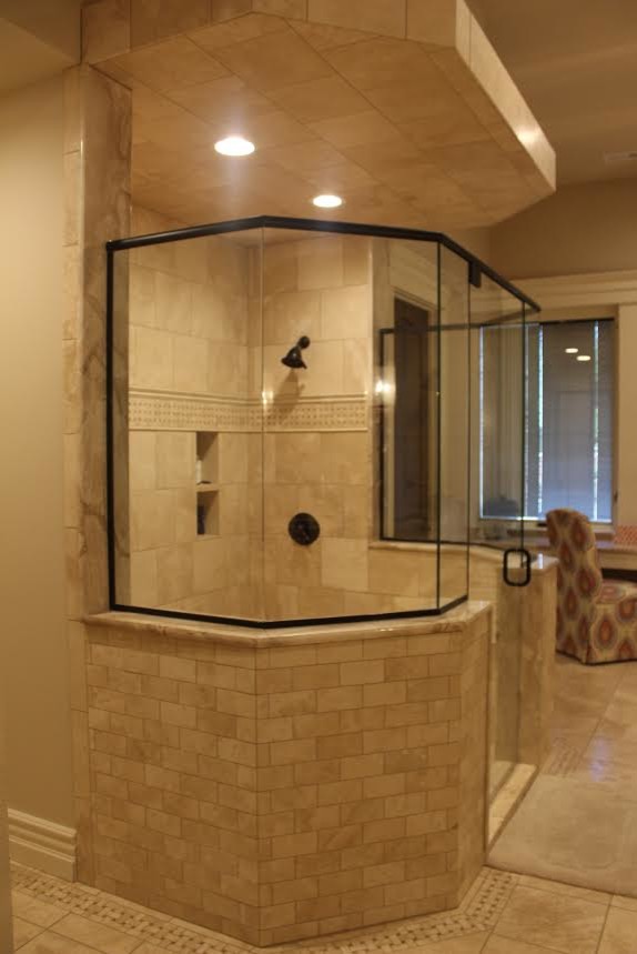 Inspiration for a mid-sized transitional master porcelain tile doorless shower remodel with granite countertops