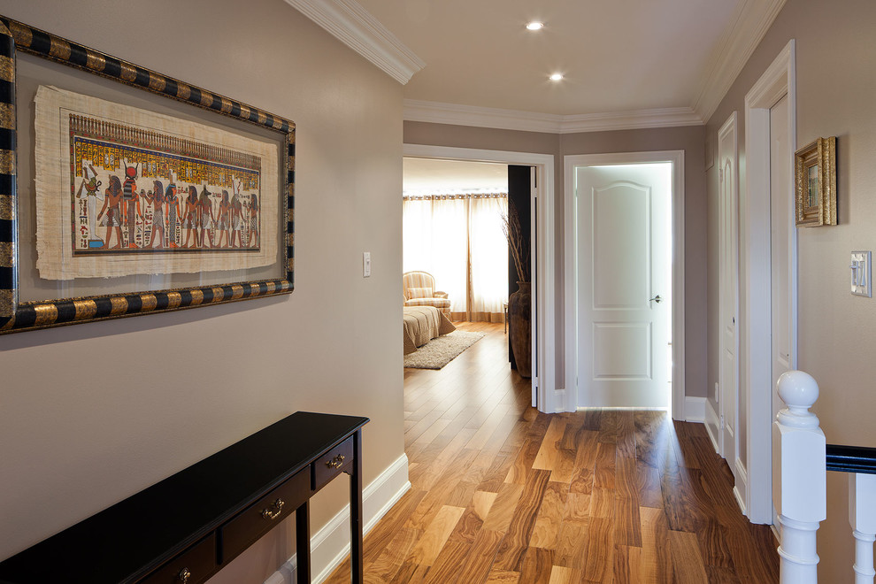 Design ideas for a mid-sized transitional hallway in Toronto with grey walls and medium hardwood floors.
