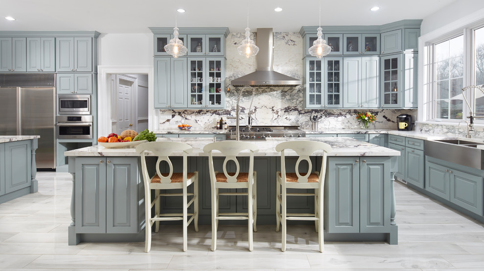Photo of a traditional kitchen in Atlanta with a farmhouse sink, multi-coloured splashback, stainless steel appliances, multiple islands and glass-front cabinets.
