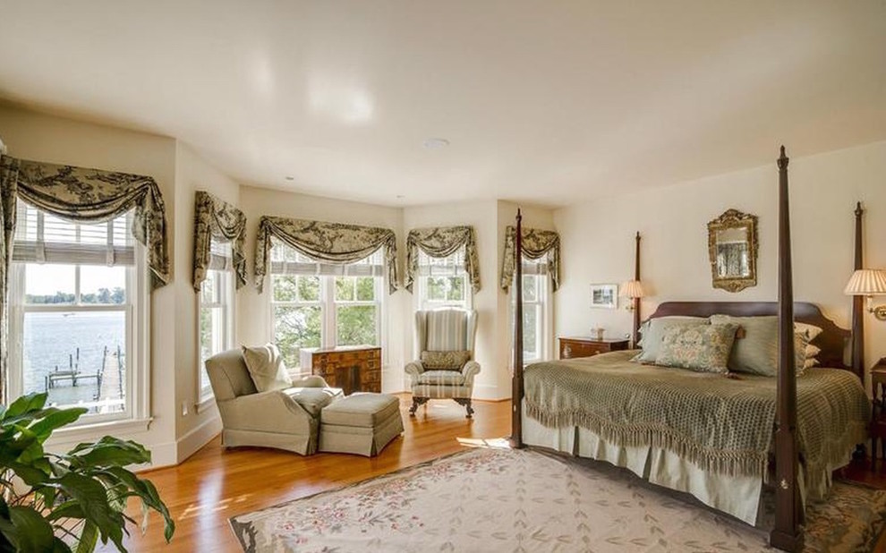This is an example of a mid-sized traditional master bedroom in Baltimore with beige walls, medium hardwood floors, no fireplace and beige floor.