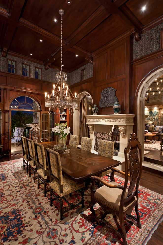 Large mediterranean separate dining room in Phoenix with brown walls, dark hardwood floors and a two-sided fireplace.