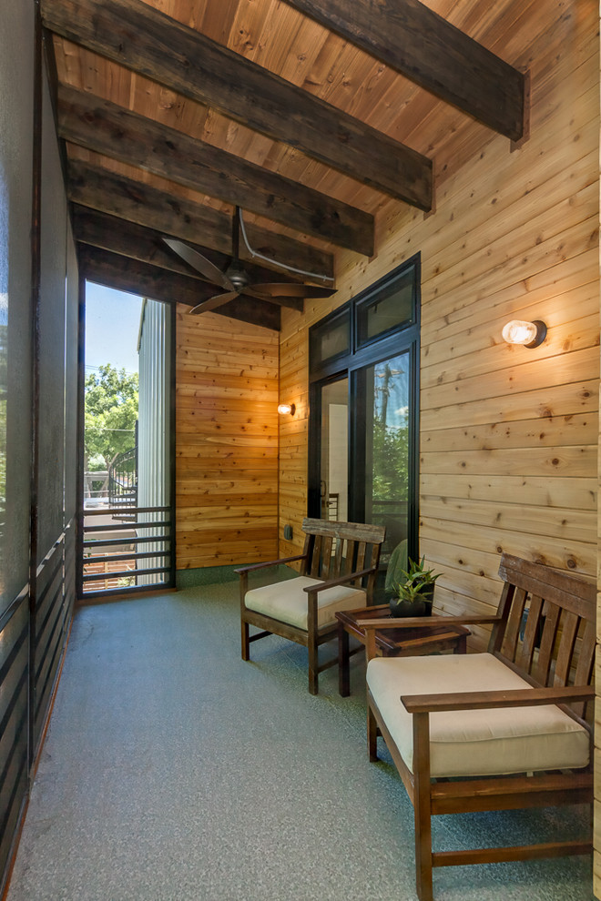 Photo of a small contemporary backyard screened-in verandah in Austin with decking and a roof extension.