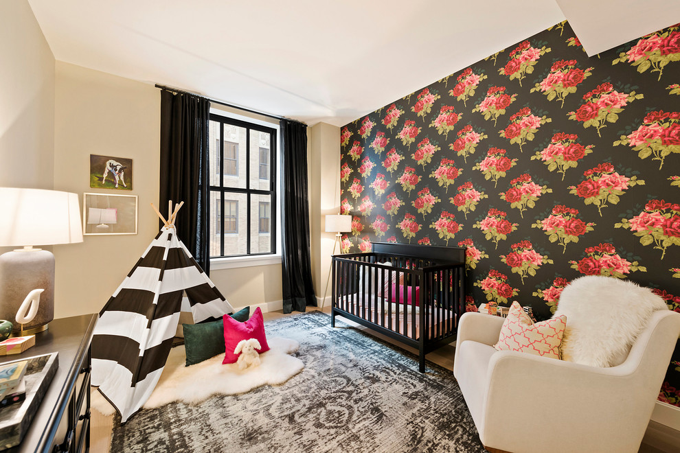 Inspiration for a large contemporary nursery for girls in New York with multi-coloured walls, light hardwood floors and beige floor.