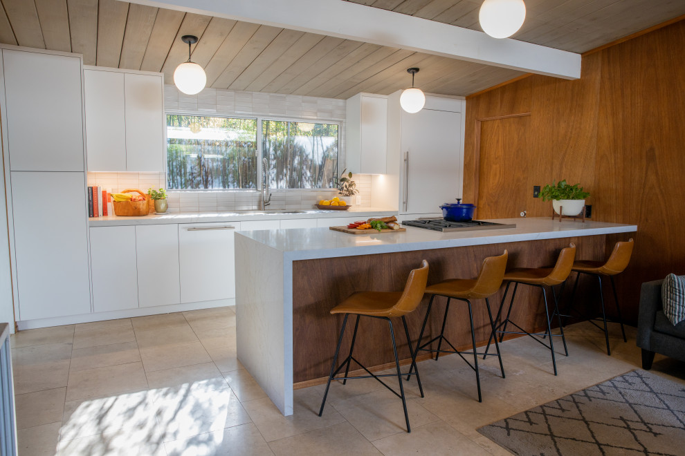 Design ideas for a midcentury eat-in kitchen in San Francisco with flat-panel cabinets, an undermount sink, white cabinets, panelled appliances, a peninsula, beige floor, grey benchtop, vaulted and wood.