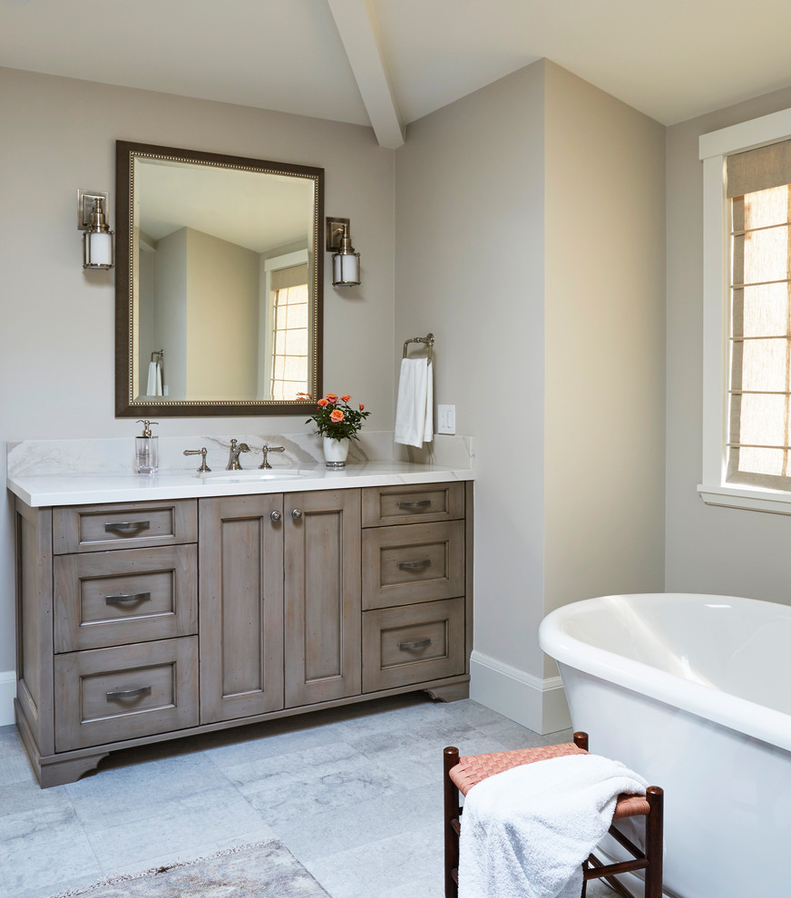 Design ideas for a mid-sized country master bathroom in San Francisco with shaker cabinets, medium wood cabinets, a freestanding tub, a two-piece toilet, white walls, porcelain floors, an undermount sink, engineered quartz benchtops, grey floor and white benchtops.