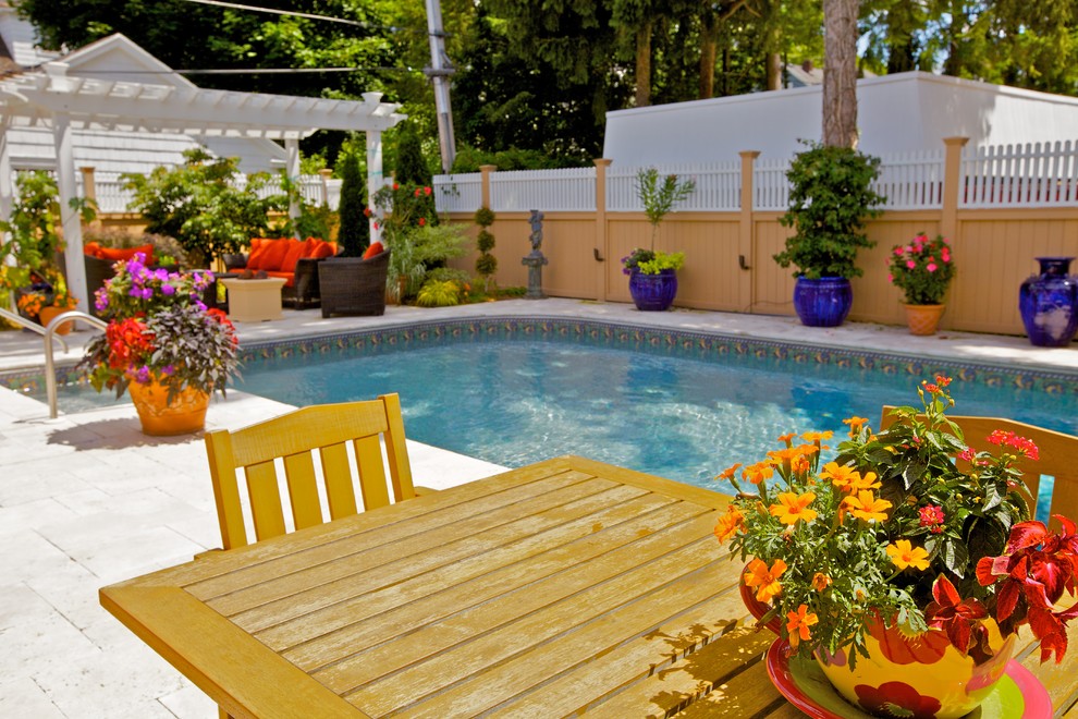 Photo of a small mediterranean backyard pool in New York with natural stone pavers.