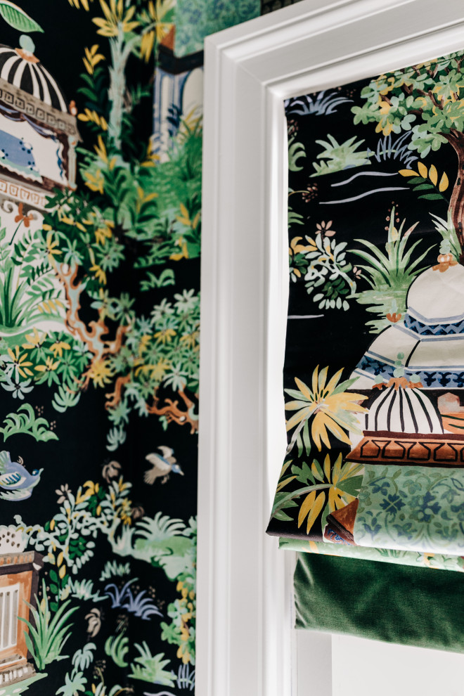 Dedicated laundry room - mid-sized eclectic u-shaped ceramic tile, black floor and wallpaper dedicated laundry room idea with an undermount sink, medium tone wood cabinets, quartz countertops, white backsplash, quartz backsplash, multicolored walls, a stacked washer/dryer and white countertops