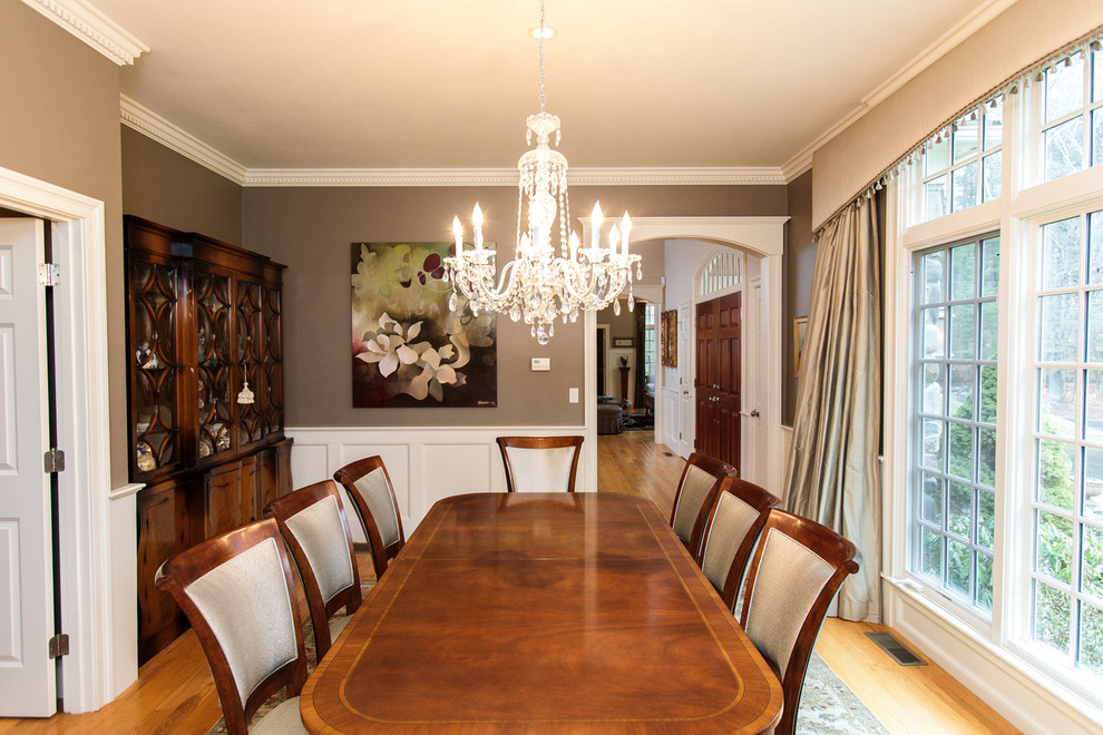 Mid-sized traditional separate dining room in Boston with beige walls, medium hardwood floors and multi-coloured floor.