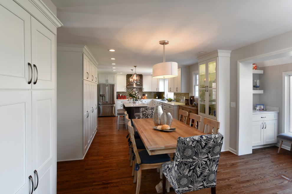 Transitional l-shaped medium tone wood floor eat-in kitchen photo in Orange County with a double-bowl sink, shaker cabinets, white cabinets, marble countertops, gray backsplash, glass tile backsplash, stainless steel appliances and an island