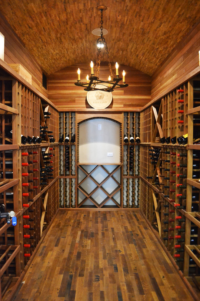 Traditional wine cellar in Austin with medium hardwood floors and storage racks.