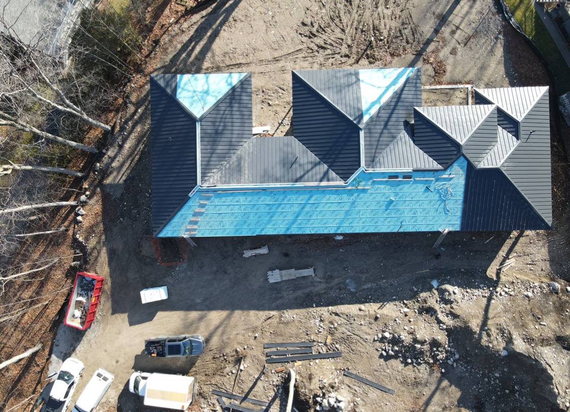 Minimalist house exterior photo in Toronto with a hip roof, a metal roof and a black roof