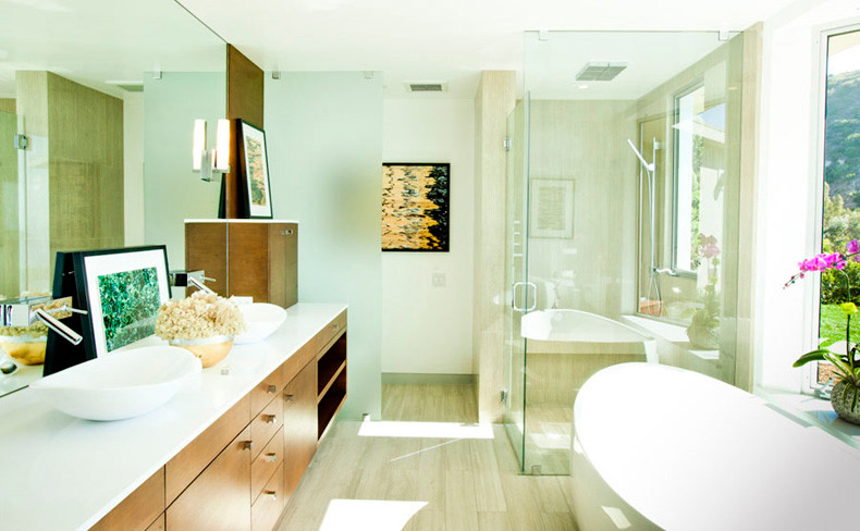 Large beach style master bathroom in Los Angeles with flat-panel cabinets, medium wood cabinets, a freestanding tub, a corner shower, a two-piece toilet, beige tile, slate, white walls, slate floors, a vessel sink, quartzite benchtops, beige floor and a hinged shower door.