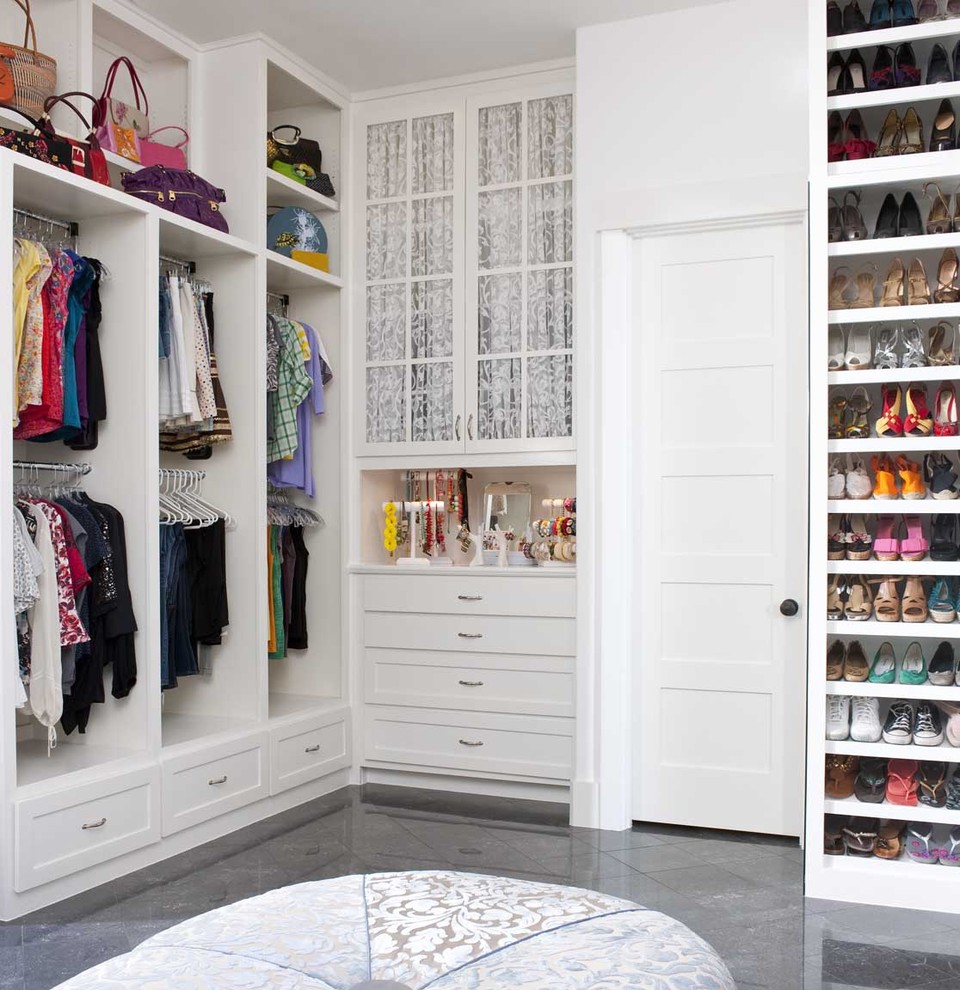 Design ideas for a transitional women's walk-in wardrobe in San Diego with white cabinets.