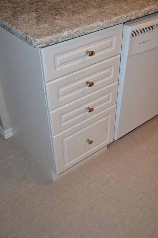 Inspiration for a mid-sized transitional u-shaped vinyl floor open concept kitchen remodel in Toronto with an undermount sink, raised-panel cabinets, white cabinets, quartzite countertops, gray backsplash, glass tile backsplash, white appliances and a peninsula