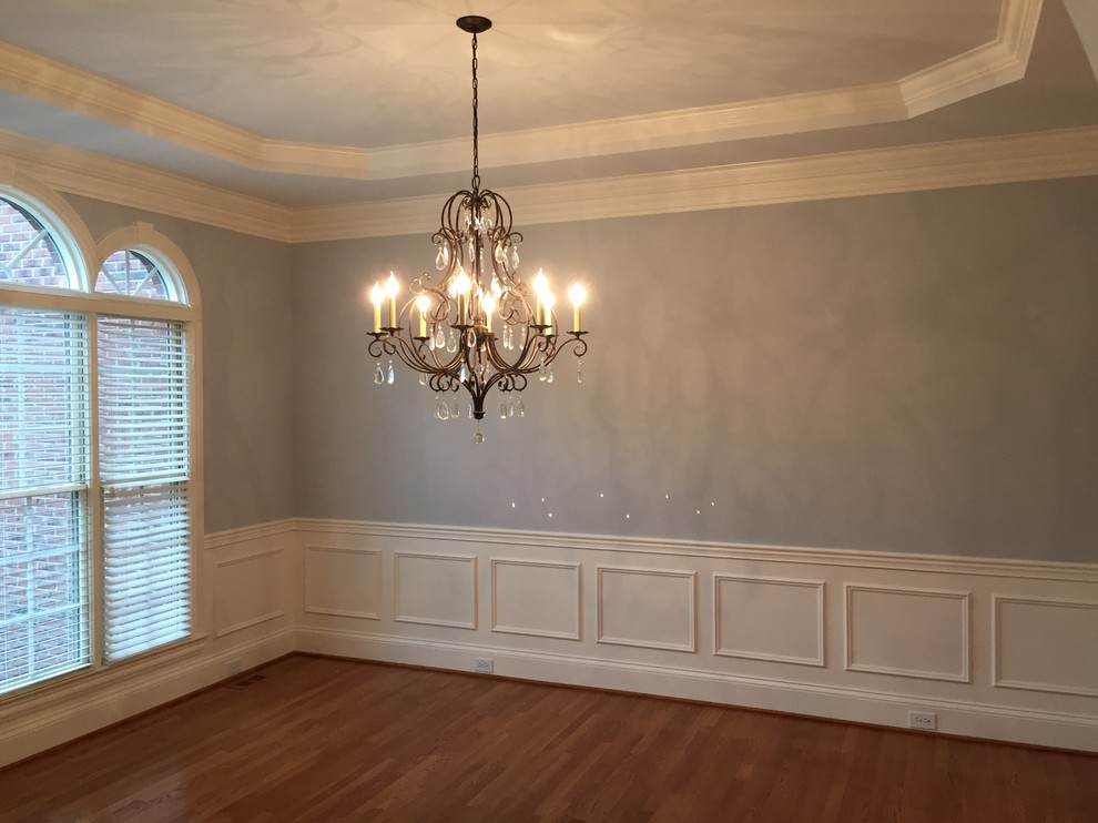 This is an example of a mid-sized traditional separate dining room in Louisville with blue walls, medium hardwood floors and no fireplace.