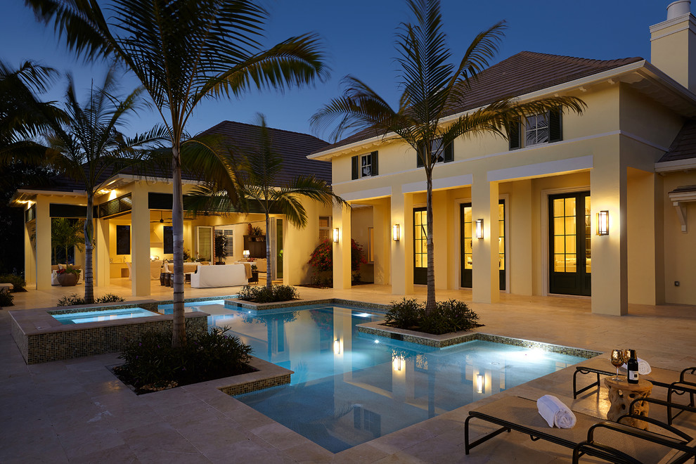Inspiration for a tropical tile and custom-shaped pool remodel in Miami