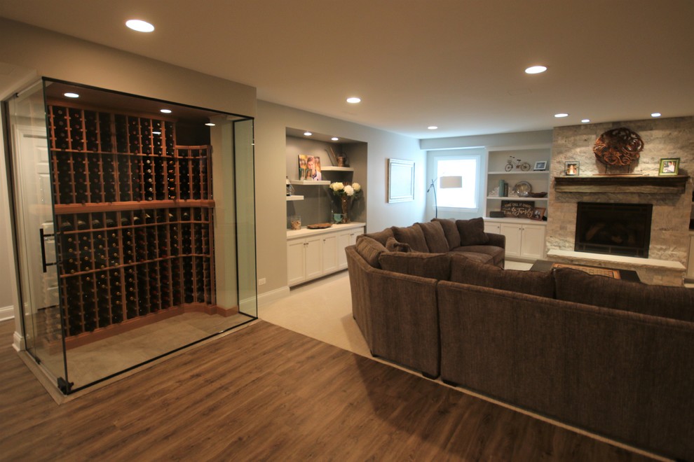 This is an example of a mid-sized country look-out basement in Chicago with grey walls, vinyl floors, no fireplace and brown floor.