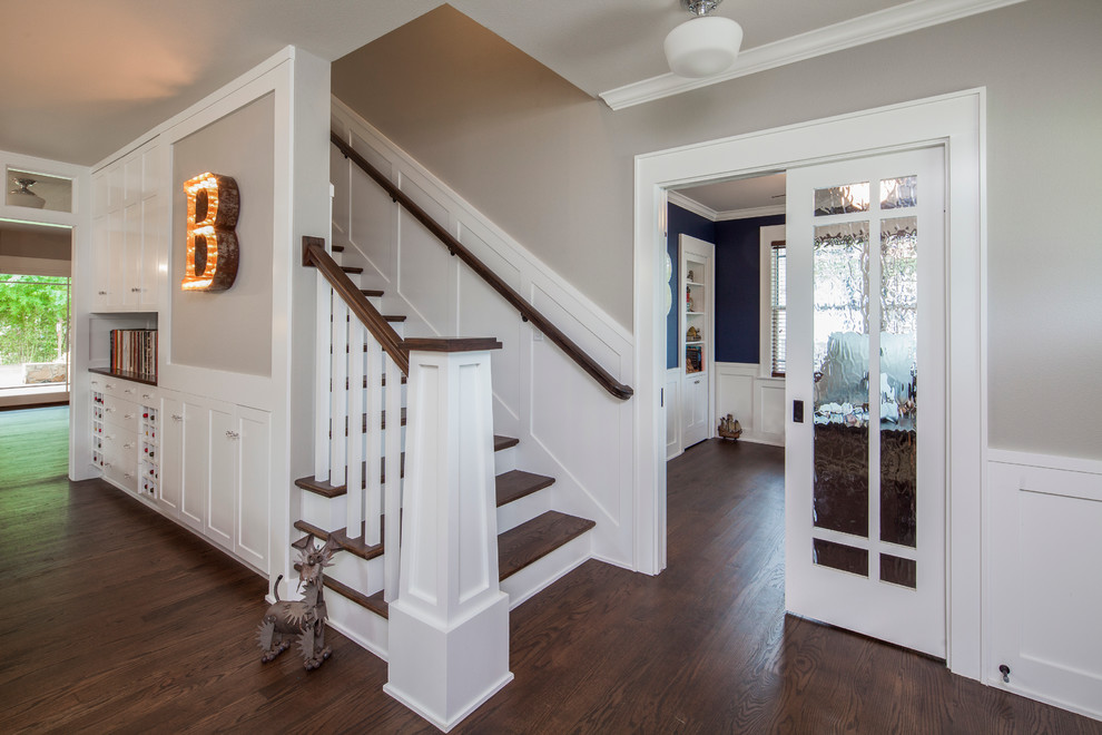 Photo of a mid-sized traditional wood straight staircase in Austin with painted wood risers.