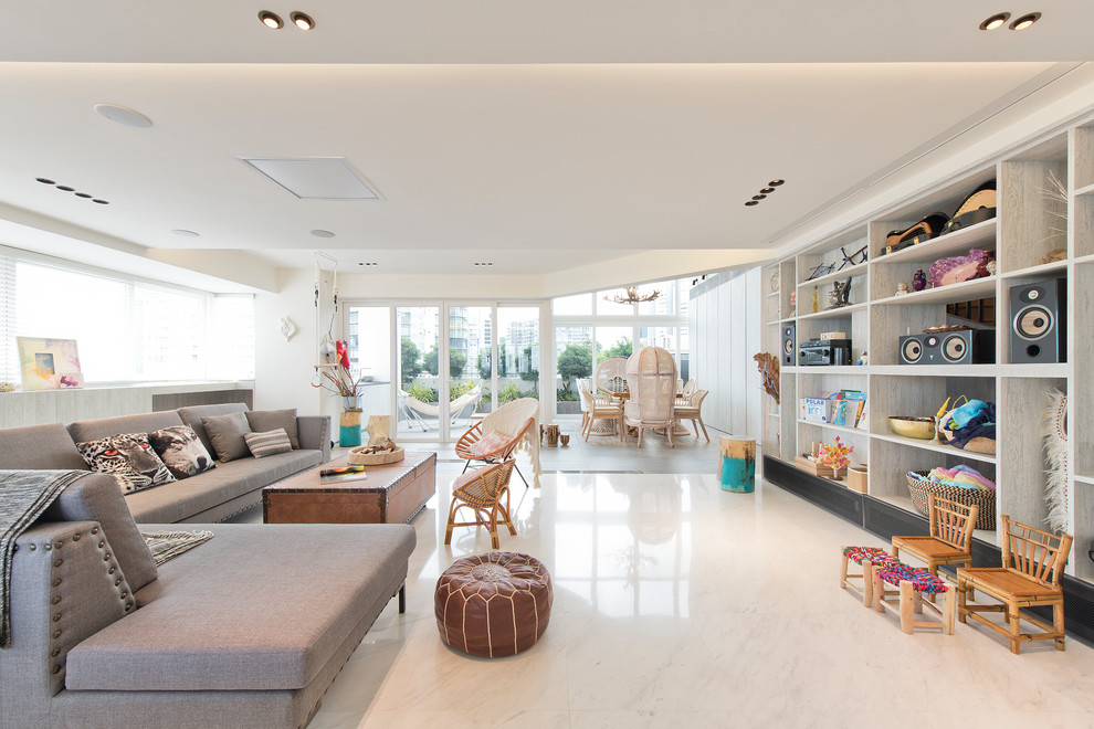 Beach style open concept living room in Singapore with white walls, a concealed tv and white floor.