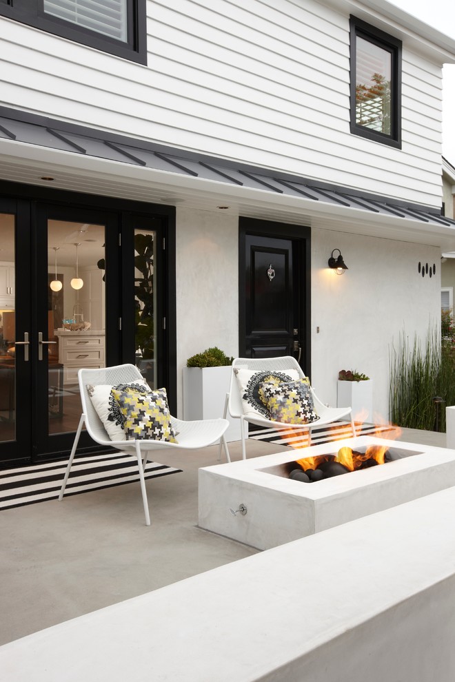 Design ideas for a transitional patio in Orange County with a fire feature.