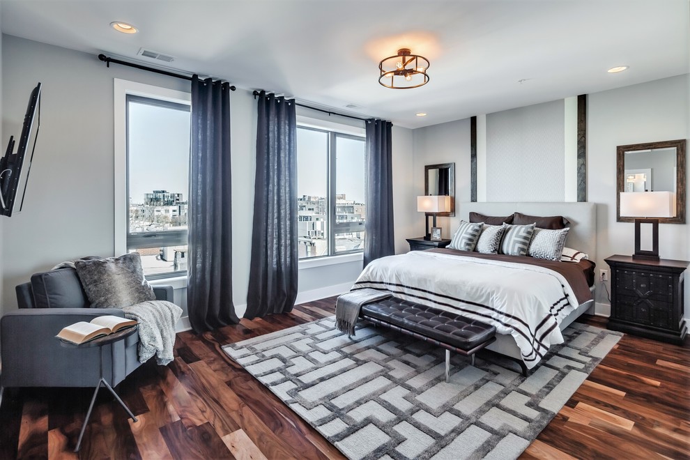 Large transitional master bedroom in Philadelphia with grey walls, medium hardwood floors, no fireplace and brown floor.