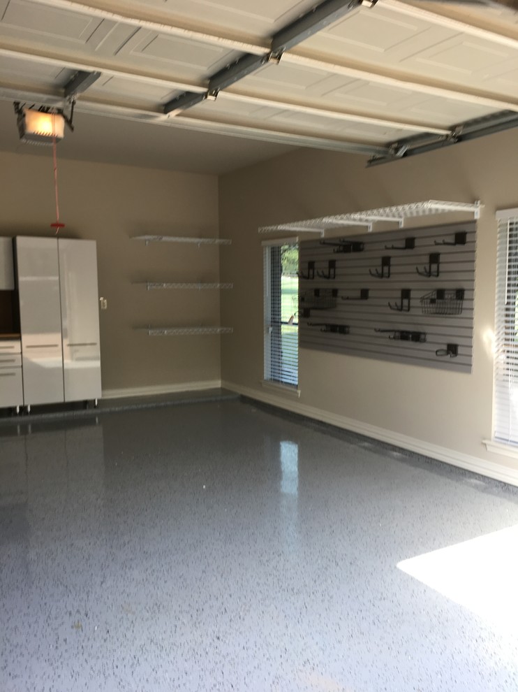 Example of a mid-sized transitional attached two-car garage workshop design in Dallas