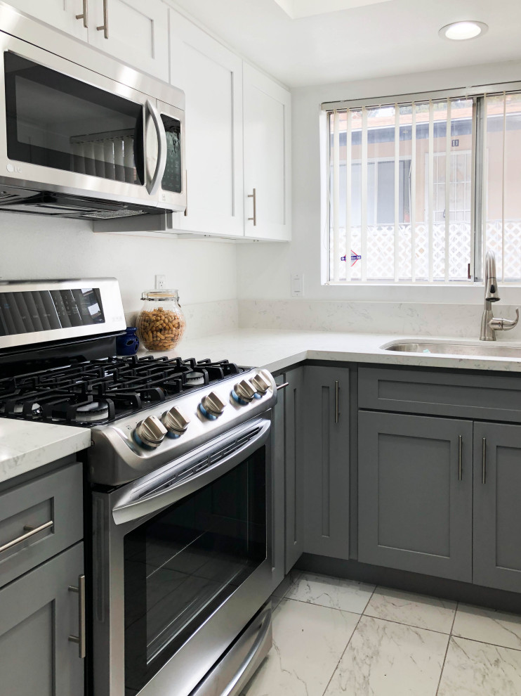 Small u-shaped separate kitchen in Los Angeles with a single-bowl sink, shaker cabinets, grey cabinets, granite benchtops, white splashback, cement tile splashback, stainless steel appliances, cement tiles, with island, white floor and white benchtop.