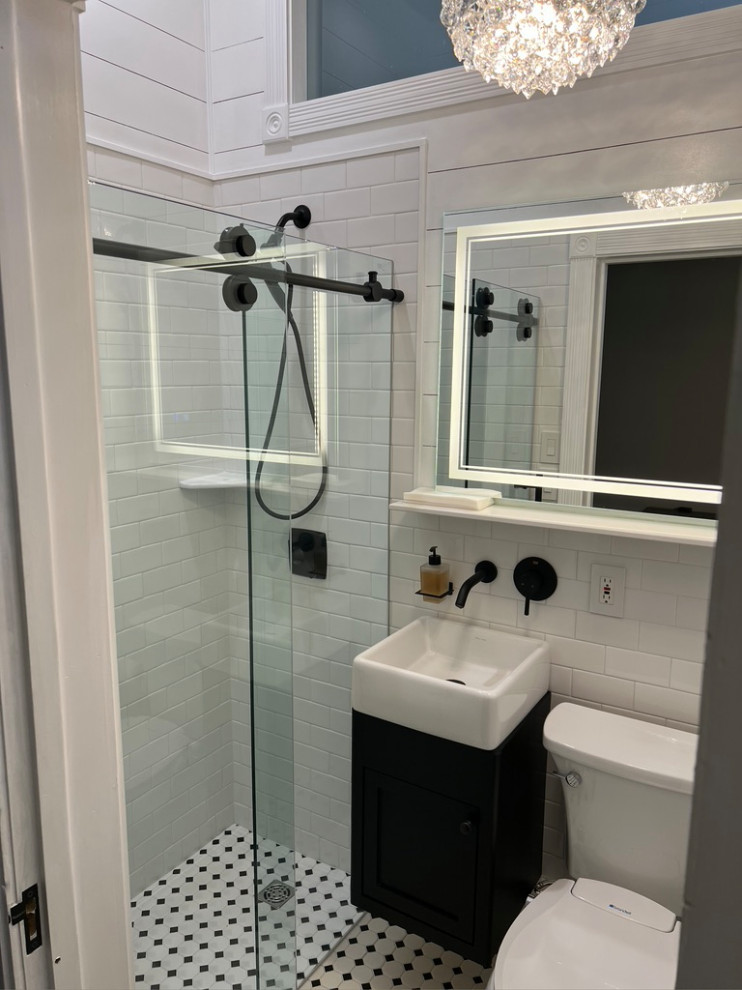 Design ideas for a small transitional 3/4 bathroom in San Luis Obispo with recessed-panel cabinets, black cabinets, a curbless shower, a two-piece toilet, white tile, ceramic tile, white walls, ceramic floors, a vessel sink, black floor, a sliding shower screen, a single vanity, a floating vanity and planked wall panelling.
