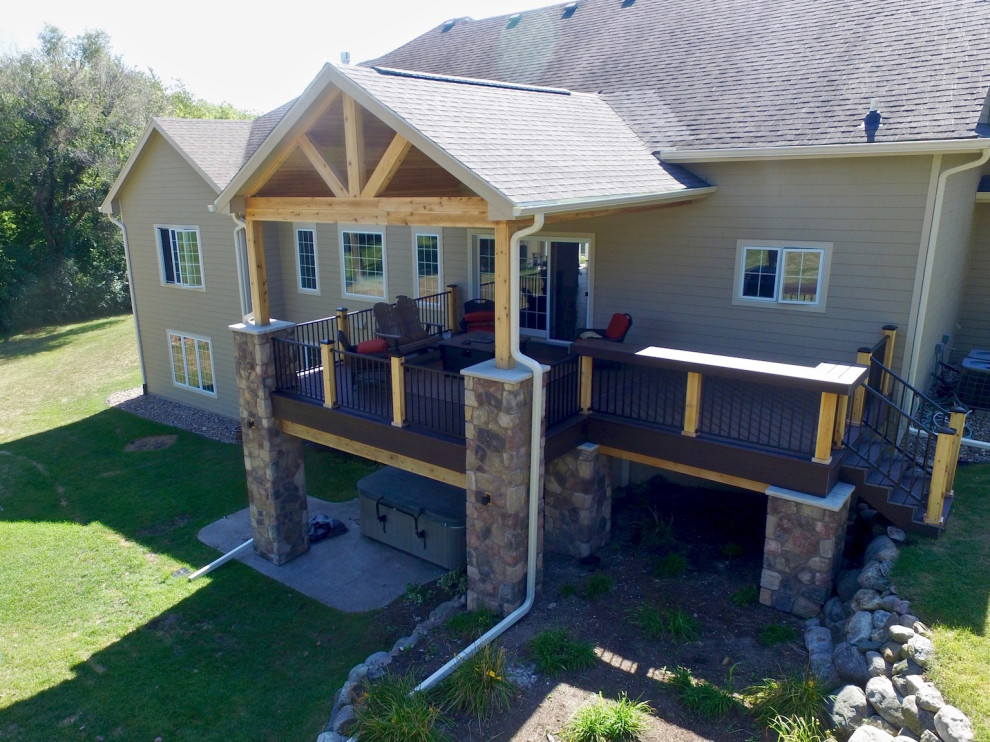 Inspiration for a mid-sized contemporary backyard verandah in Other with with columns.